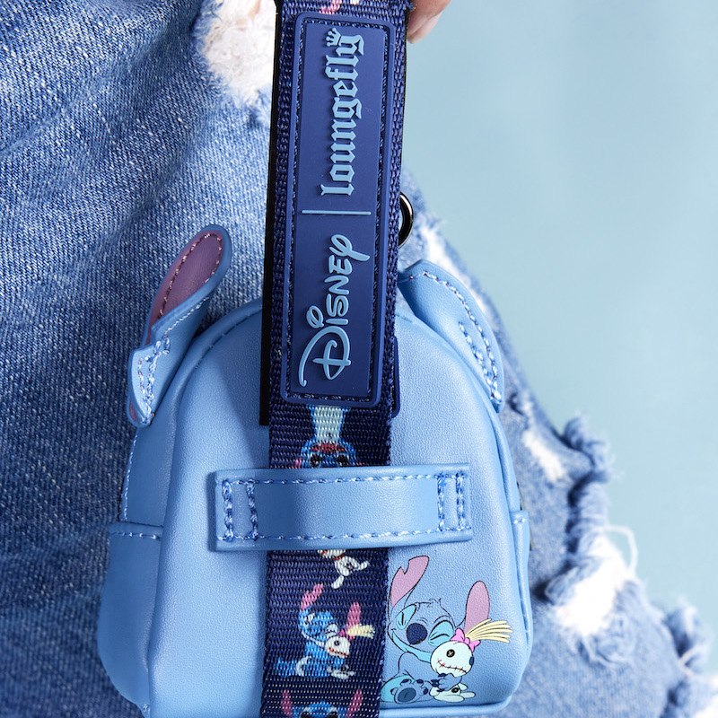 Image of someone holding the Disney Stitch Leash with the Stitch Treat Bag attached 